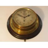 An early 20th Century brass cased ships clock on oak mount,