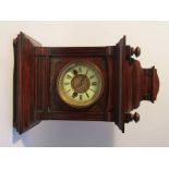 A late 19th Century mahogany mantel clock of architectural form, enamelled Roman chapter ring,