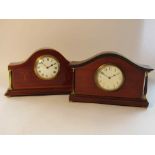 Two Edwardian mahogany timepieces of architectural form with brass bun feet and columns,