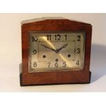 An early to mid 20th Century walnut and ebonised Deco style mantel clock,