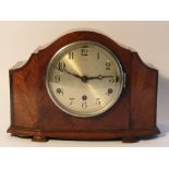 An early to mid 20th Century walnut veneered mantel clock,