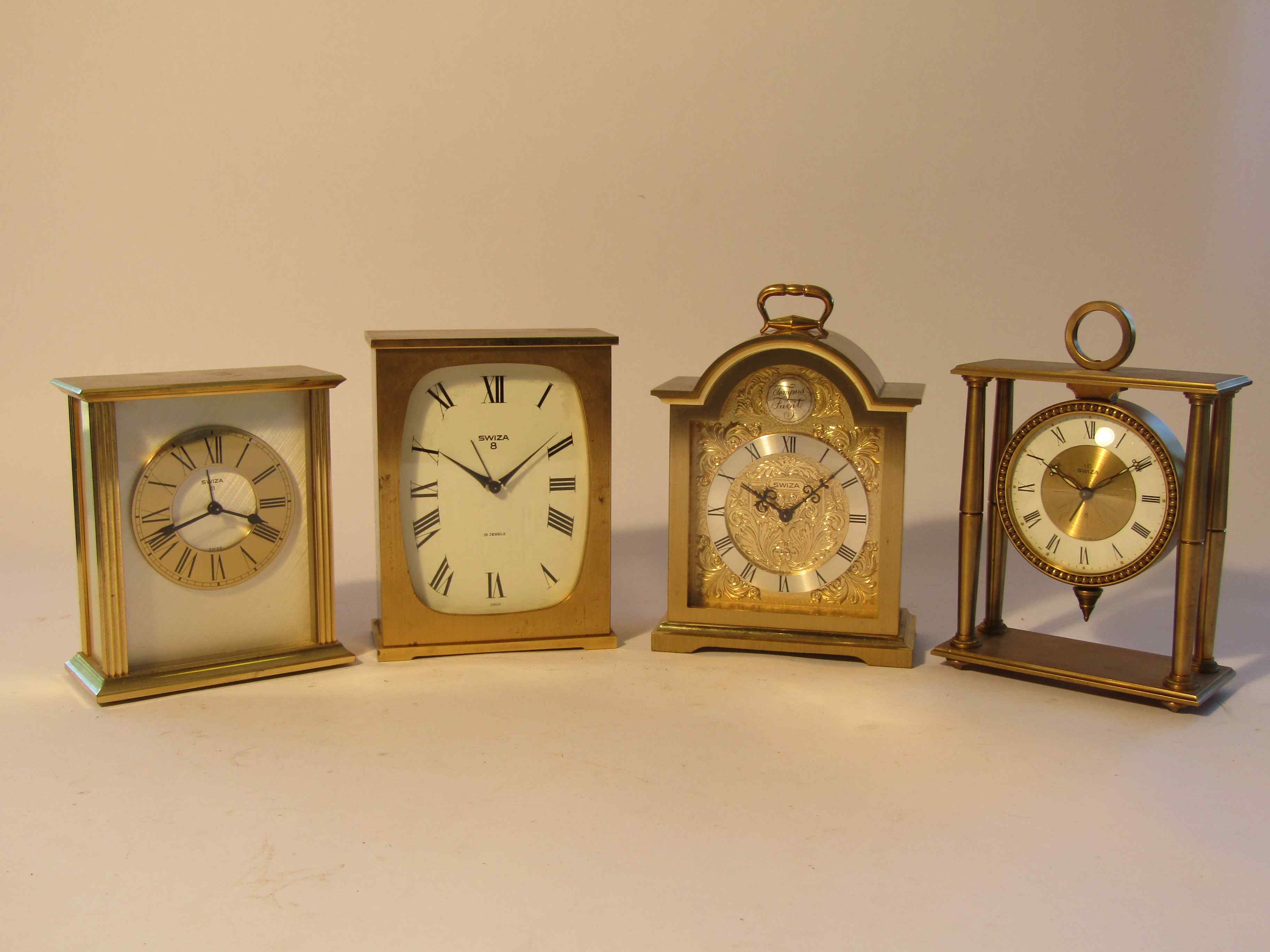 Four mid to late 20th Century Swiza 8 day carriage alarm clocks