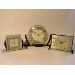 Three early to mid 20th Century Deco style English desk timepieces in chrome and cream/black