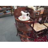 A mahogany corner washstand with single drawer and shaped undertier,