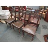 A set of six Victorian dark stained dining chairs with upholstered seats,