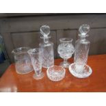 Two crystal decanters together with a selection of crystal items including milk jug and candle