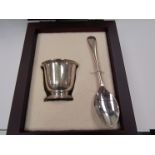 A modern cased silver egg cup and spoon