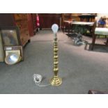 A turned brass table lamp base