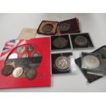 A selection of old coins including commemorative crowns and a 2003 souvenir set
