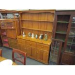 A modern pine dresser with plate rack top,