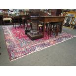 A large wool carpet in blues and reds,