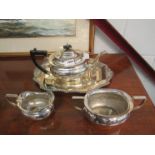 An electroplated teapot, milk jug and sugar bowl.