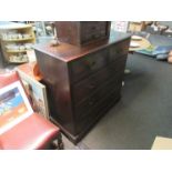 A George III style oak chest of two short over three graduating long drawers on bracket feet,