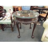 An early 20th Century mahogany circular top occasional table with carved foliate frieze ball and