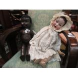 Two vintage dolls including Pedigree black baby and blue eyed porcelain faced