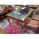 An 18th Century style walnut writing table with tooled leather top, shell relief cabriole legs,