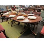 A Regency-style mahogany twin-pedestal "D"-end dining table with reeded edges,