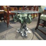 A figural elephant base table with glass top