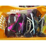 A basket of miscellaneous sunglasses