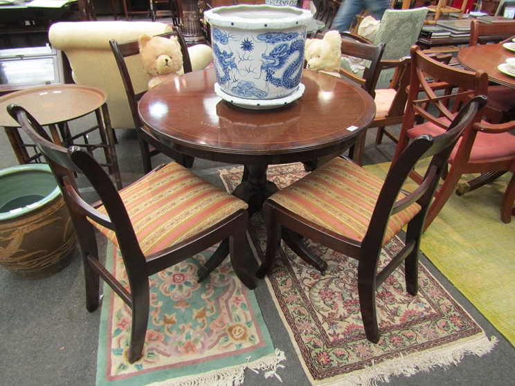 A Regency style circular centre table and a set of four matching chairs,