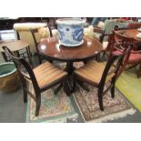 A Regency style circular centre table and a set of four matching chairs,