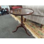 A mahogany dish top wine table on tripod base,