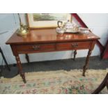 An Edwardian mahogany two-drawer side table on ring-turned legs
