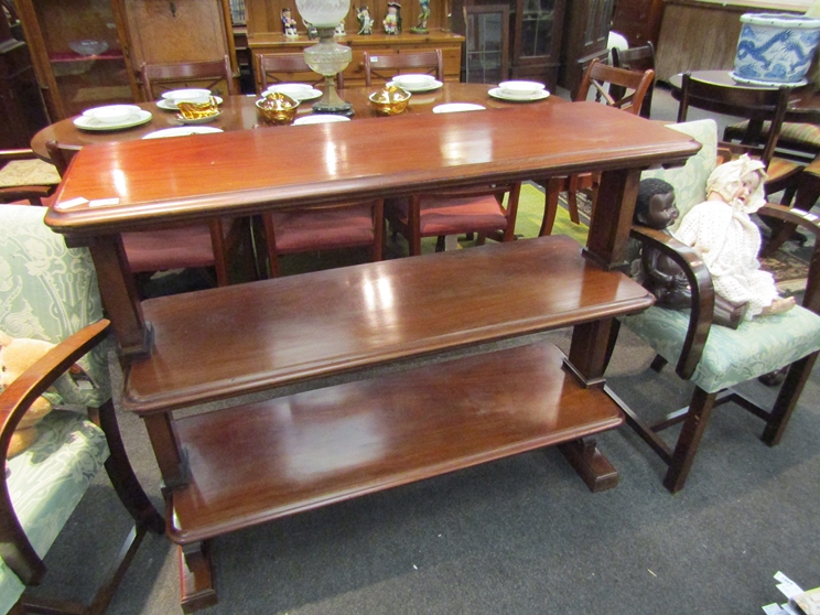 A Victorian mahogany three tier buffet, scrolled detail,