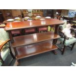 A Victorian mahogany three tier buffet, scrolled detail,