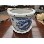 A blue and white ceramic jardiniere with dragon pattern, with saucer, 31cm tall,