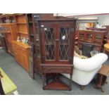 An oak corner unit with bobbin turned legs, carved 1924-1999,