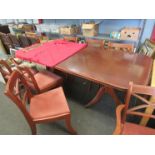A large mahogany dining table with extra leaf,