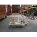 A fishing trawler model boat on stand