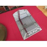 An etched glass wall mirror,