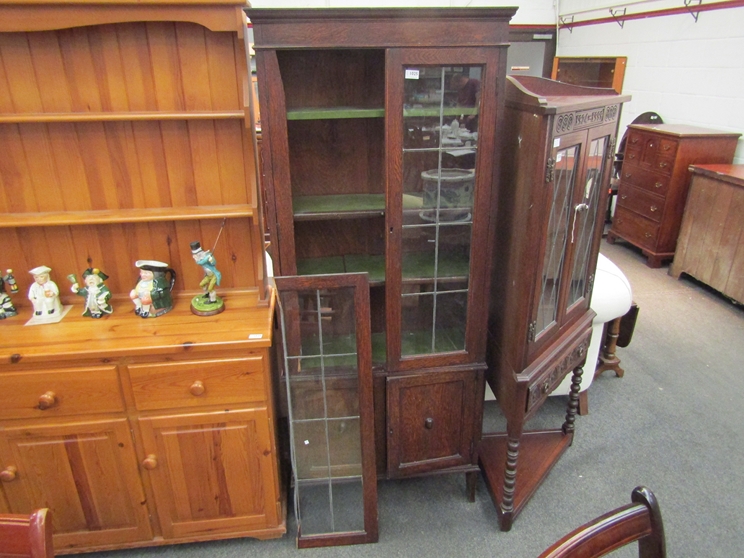 An early 20th Century oak astral glazed bookcase on two door cupboard base a/f,