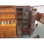 An early 20th Century oak astral glazed bookcase on two door cupboard base a/f,