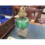 A green glass reservoir oil lamp,