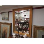 A large gilt mirror with bevel edge,