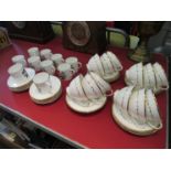 Twelve Royal Doulton "Covington" cups and saucers and ten Royal Worcester "White Rose" cups and