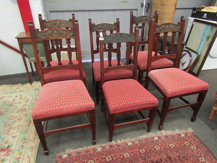 A set of six Arts & Crafts era dining chairs with embossed copper back panels,