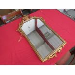 A gilt framed wall mirror with flower basket crest,