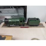 A painted wooden model steam engine on track