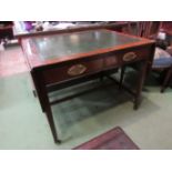 A 19th Century mahogany writing desk the tooled leather insert and rising leaves over two frieze