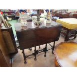 An Edwardian mahogany Georgian style occasional table the rising leaves over ring turned cabriole