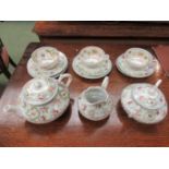 A floral design teaset comprising of three trios, milk jug,