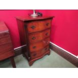 A Georgian style crossbanded burr walnut serpentine front four drawer chest of small proportions,