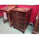 A Georgian style flame mahogany filing cabinet the tooled leather insert over two drawers on