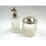 A silver topped jar and perfume bottle,