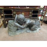 A bronze garden water feature of boy drinking from bucket of water, 60cm long,