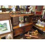 A late Victorian walnut wall hanging shelf with turned spindle gallery over two doors with key,